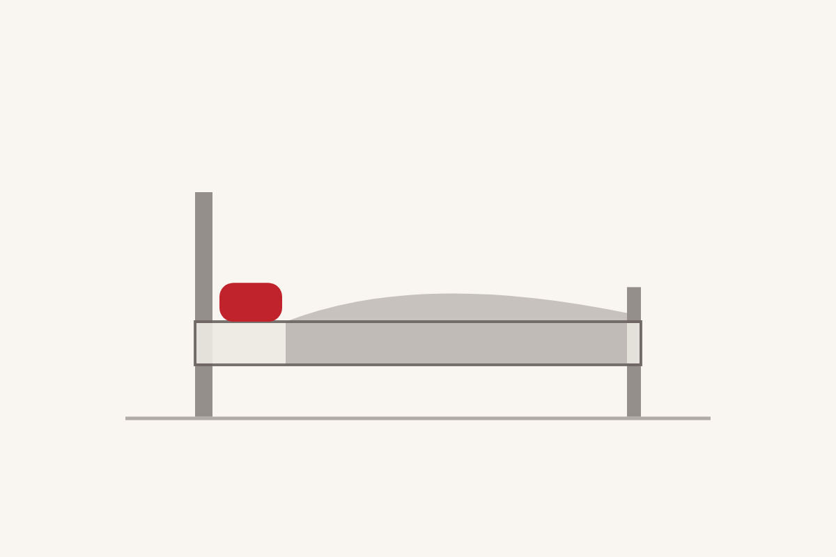 Qué dice de ti tu cama: una cama dibujada en gris con una almohada roja